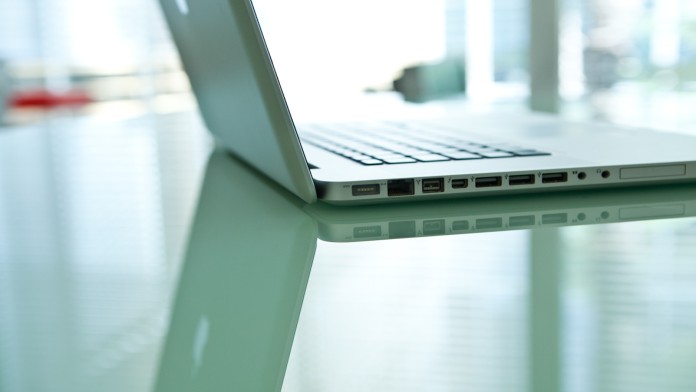 Opened laptop on a mirrored desk