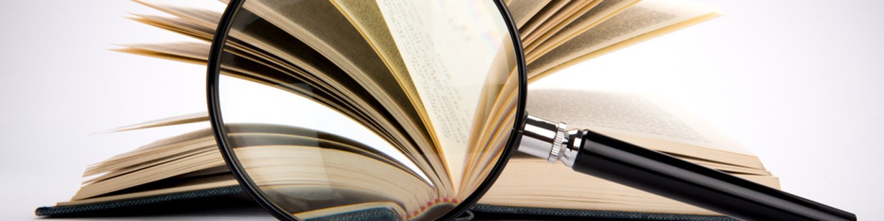 A magnifying glass in front of a book