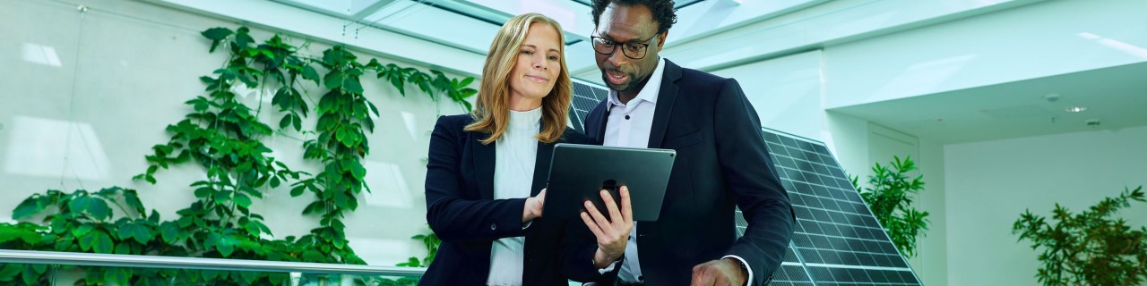 Two people looking at an iPad