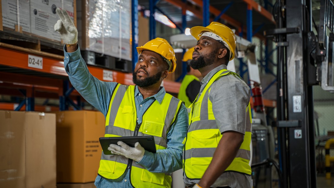 Two mean checking a logistics facility